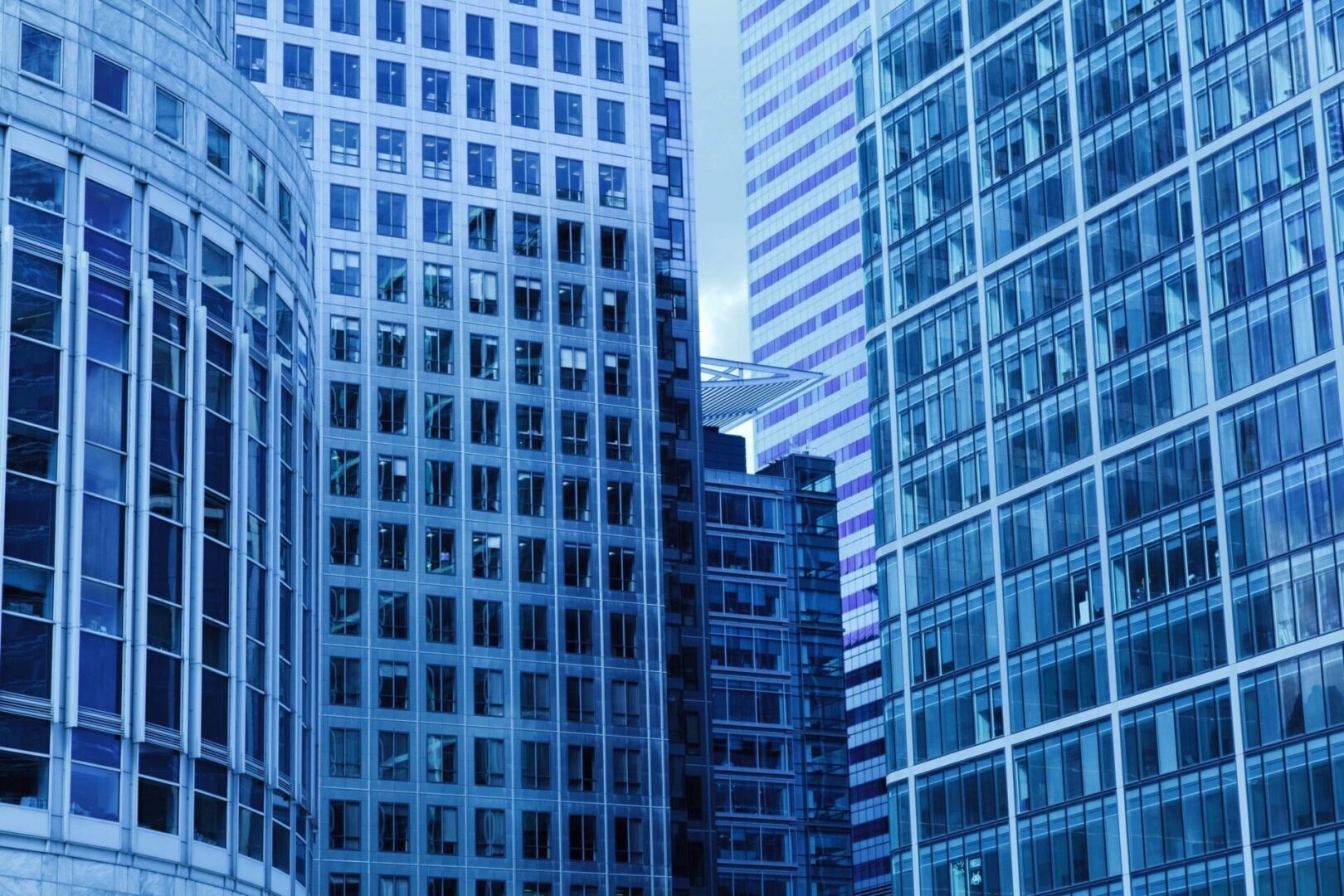 A group of tall buildings with windows in the background.